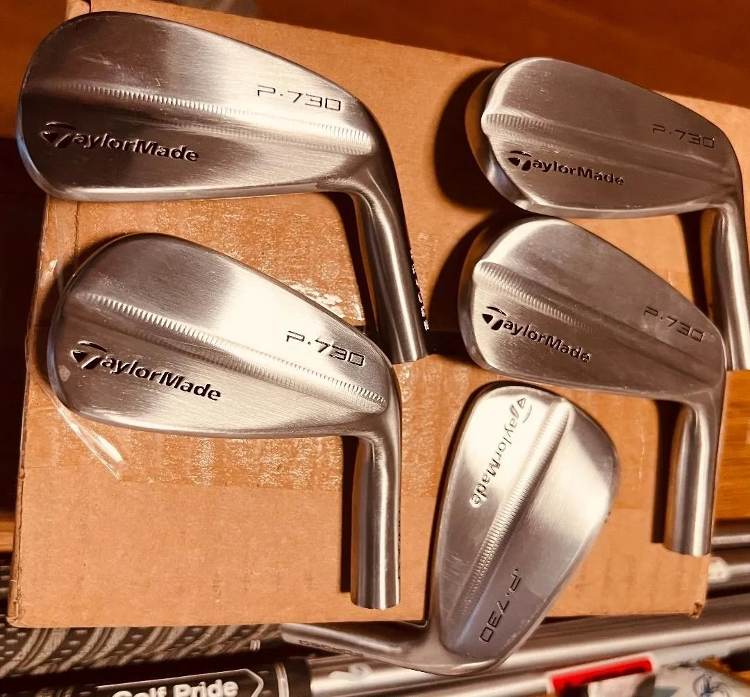 Forged iron heads on the bench at Blades Golf Repair
